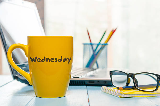 Wednesday coffee cup at office workplace. Morning job background with Wednesday coffee cup at office workplace. Morning job background with laptop and glasses. wednesday morning stock pictures, royalty-free photos & images