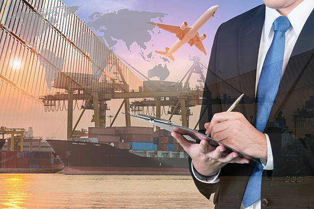 istock Double exposure of businessman is booking with blurred cargo 615719384