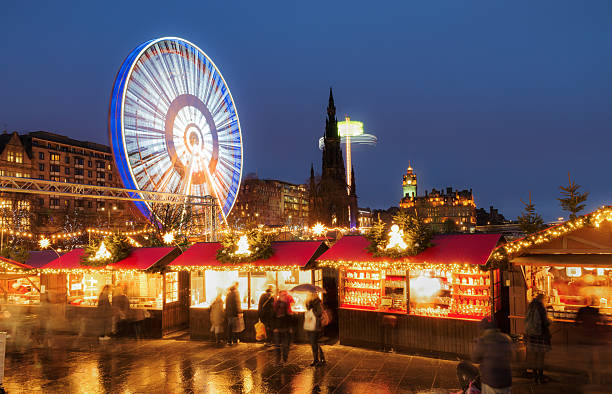Christmas markets and amusement rides in central Edinburgh, Scotland People browsing winter market stalls, just off Princes Street in Edinburgh's city centre during the run-up to Christmas and Hogmanay, the city's famous New Year's celebrations. hogmanay photos stock pictures, royalty-free photos & images
