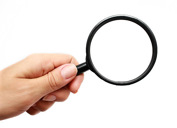 Hand with magnifying glass. stock photo
