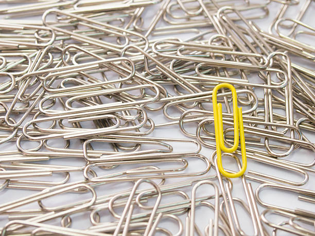 istock Yellow paper clip stand different from the crowd 615719562