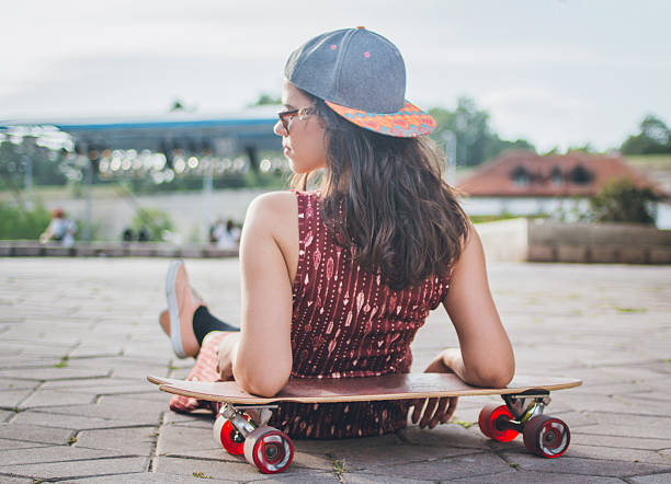 bela e moda jovem mulher posando com skate - women sea cheerful surfing imagens e fotografias de stock
