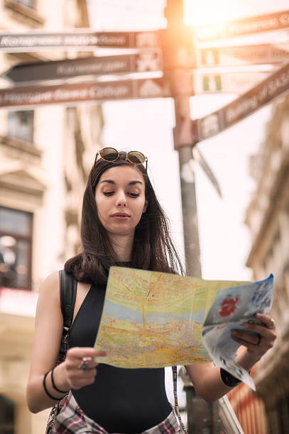 istock Young tourist in the city looking a map 615722768