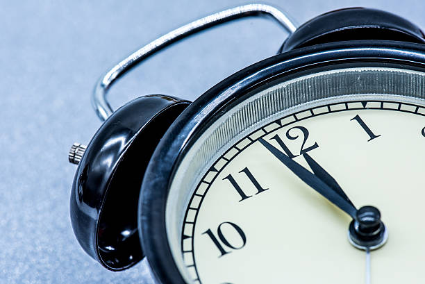 istock alarm clock at midnight for Christmas and New Year 615724586