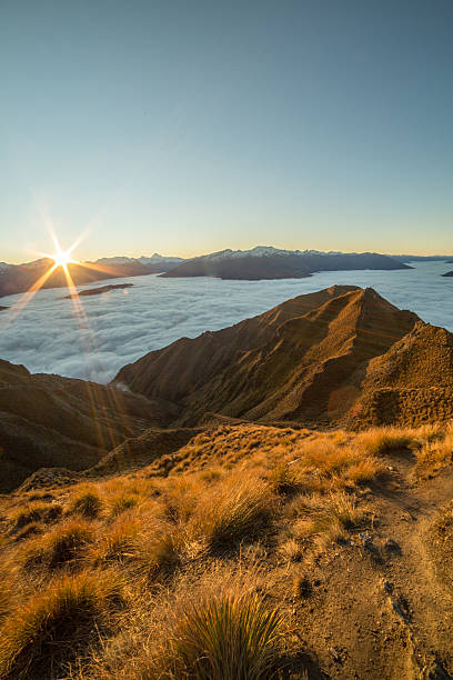 istock View from mountain summit, sunset above the clouds 615726356