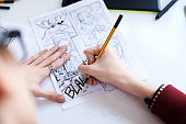 Male hands drawing the comics
