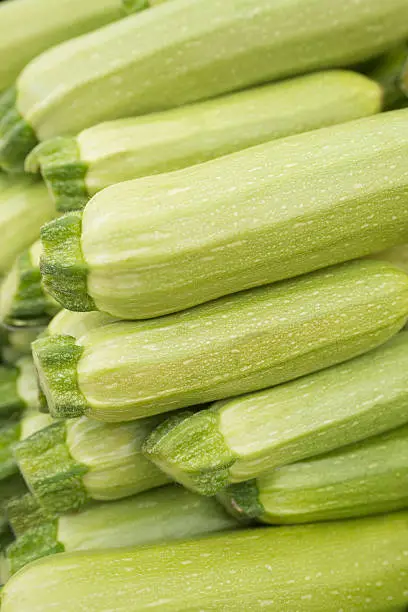 Photo of Fresh cropped green Zucchini; Offer in the vegetable market;