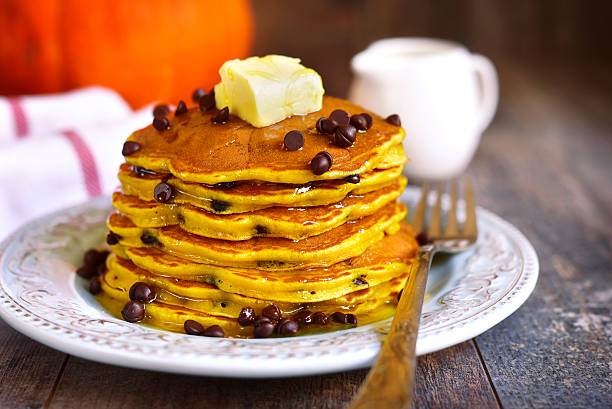 istock Pumpkin pancakes with chocolate drops on a rustic background. 615727866