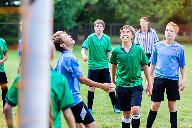 istock Opposing soccer teams look for ball 615730420