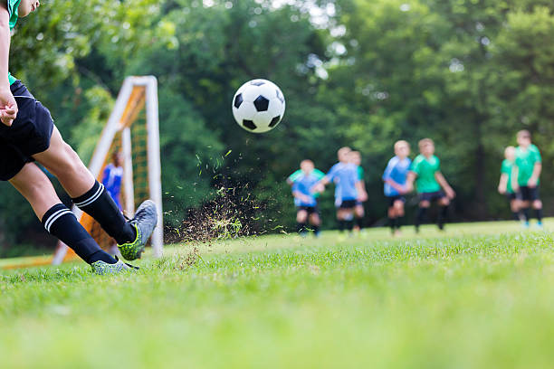 istock Soccer ball is in mid air while player takes shot 615730474
