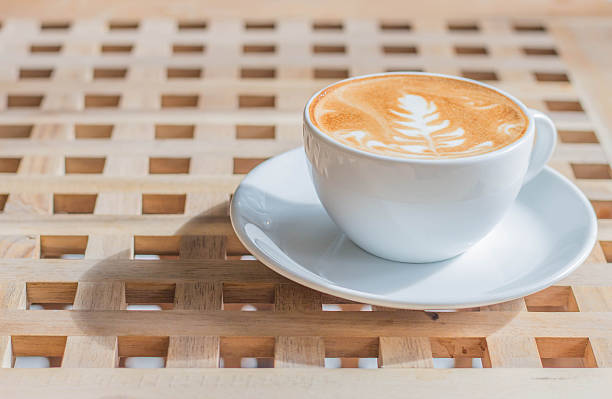 istock cup of coffee with latte art on wooden table 615730812