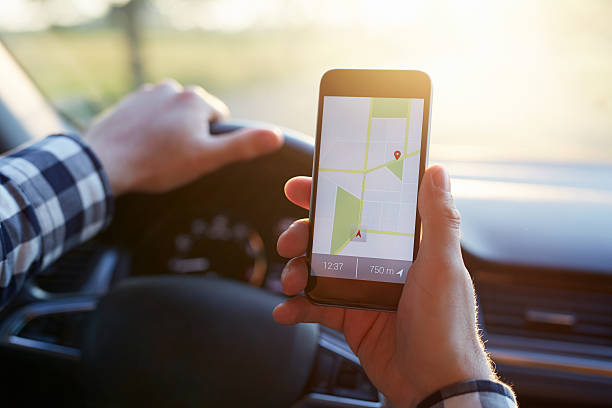 istock Male hand holding mobile phone with gps map 615731362