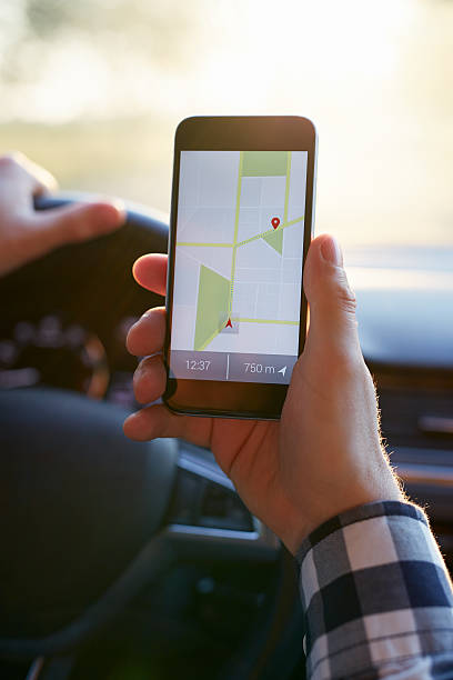 istock Male hand holding black mobile phone with gps map 615731434