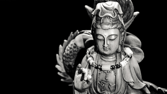 Black and white style of Buddha statue with light dark background . buddha image used as amulets of Buddhism religion.My's amulets .Photo taken on: September 22, 2016