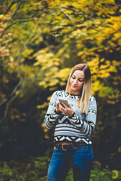 istock girl using phone in the nature 615733796