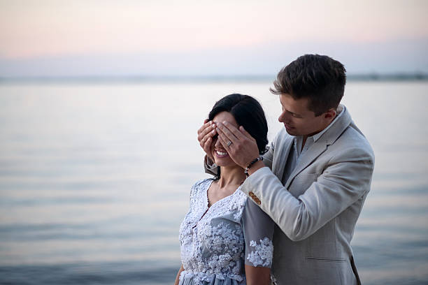 istock young couple on a beach at sunset 615735444