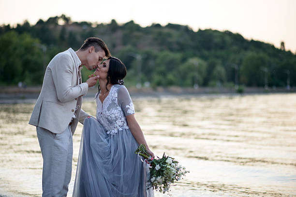 istock young couple on a beach at sunset 615735702