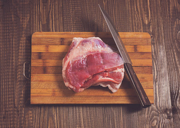 istock On plank are pork and knife 615736214