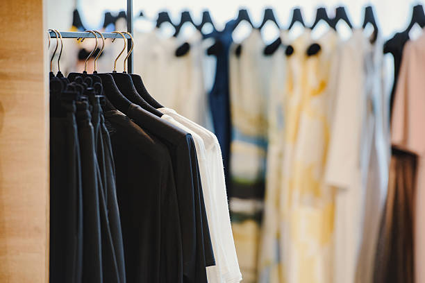 istock Clothes on hangers in a retail shop 615736944