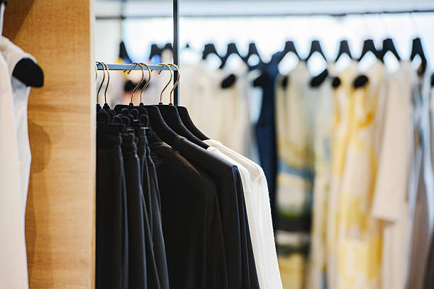 istock Clothes on hangers in a retail shop 615737054