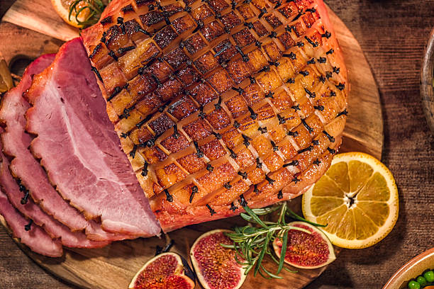 istock Glazed Holiday Ham with Cloves Background 615737308