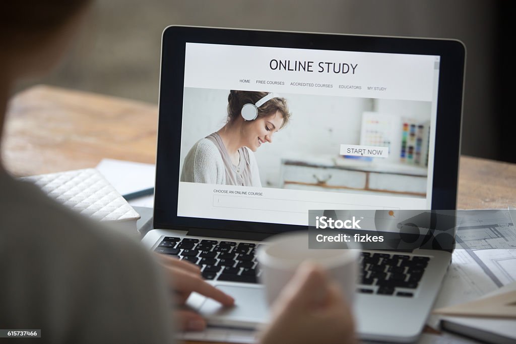 Open laptop on the desk, with online study on screen Open laptop on the desk with a title online study on the screen. Education concept photo, view over the shoulder, close-up Internet Stock Photo
