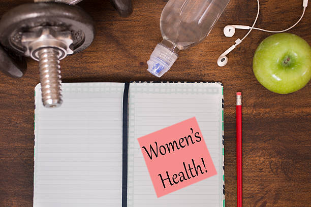 istock Fitness, exercise themed scene with Women's Health note. 615737480