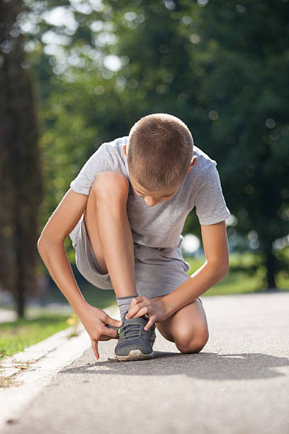 istock Cute little boy preparing for running and trainig in nature 615738378