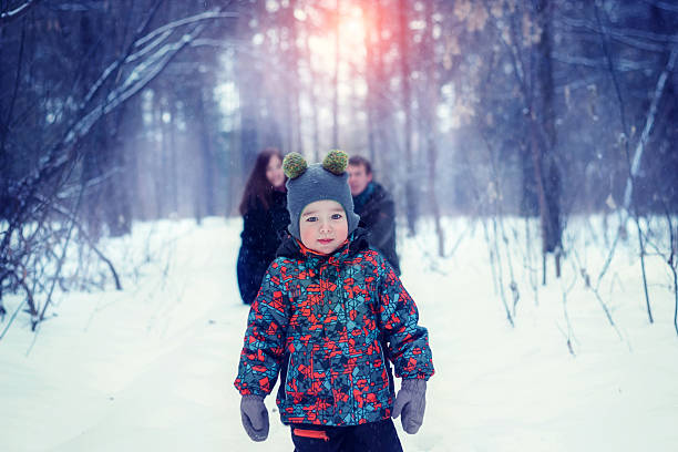 istock Mom dad and son in the winter forest 615738546