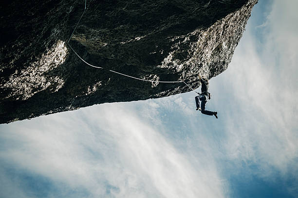 istock Woman hanging from cliff 615738744