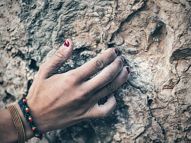istock Female climber hand  gripping rock 615738788