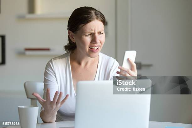 Portrait Of A Woman The Laptop Looking Screen Of Mobile Stock Photo - Download Image Now