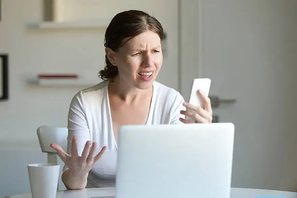 Photo of Portrait of a woman the laptop, looking screen of mobile