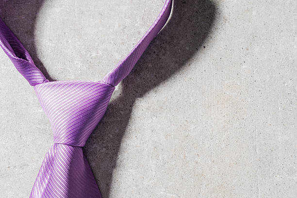 istock Elegant necktie on gray stone background 615739490