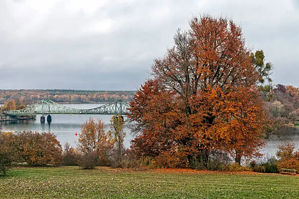 Glienicke Bridge between Potsdam and Berlin in autumn seen from the Babelsberg Park. Until 1989, during the time of Cold War, this bridge was the border between East and West.