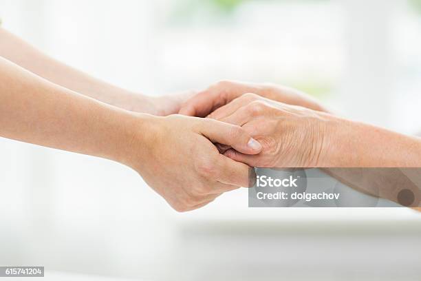 Close Up Of Senior And Young Woman Holding Hands Stock Photo - Download Image Now - Holding Hands, Home Caregiver, Hand