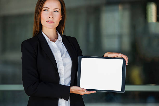 istock Business woman with a tablet pc (blank screen) 615743510