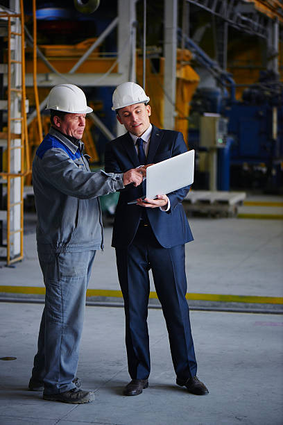 istock Man in a suit and a worker in overalls 615743558