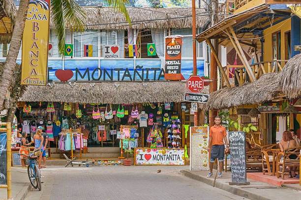 Street of Montanita Ecuador Montanita, Ecuador - October 23, 2015: Picturesque urban scene at street with lots of stores in Montanita, the most famous watering place in Ecuador montanita ecuador stock pictures, royalty-free photos & images