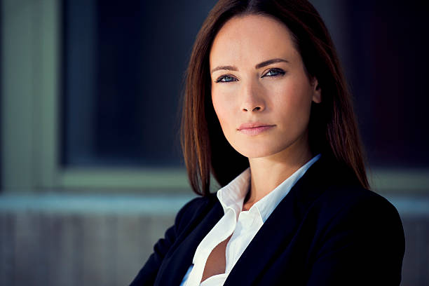 Business woman close up Business woman in suit outfit close up portrait, in front of a blurry background chief leader stock pictures, royalty-free photos & images