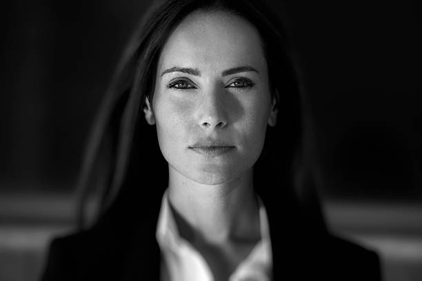 Business woman close up Business woman in suit outfit close up portrait, in front of a blurry background serious photos stock pictures, royalty-free photos & images