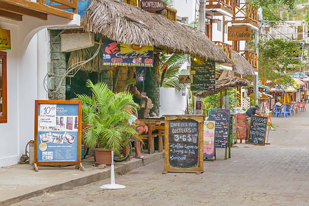 Street of Montanita Ecuador Montanita, Ecuador - October 23, 2015: Picturesque urban scene at street with lots of stores in Montanita, the most famous watering place in Ecuador montanita ecuador stock pictures, royalty-free photos & images