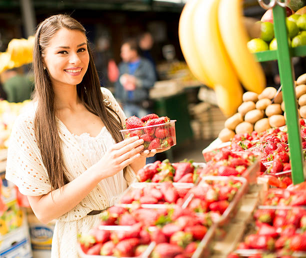 istock Young woman  at the market 615744358