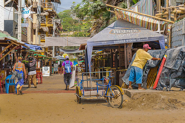 Street of Montanita Ecuador Montanita, Ecuador - October 23, 2015: Picturesque urban scene at street with lots of stores in Montanita, the most famous watering place in Ecuador montanita ecuador stock pictures, royalty-free photos & images