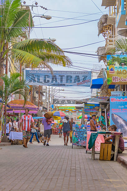 Street of Montanita Ecuador Montanita, Ecuador - October 23, 2015: Picturesque urban scene at street with lots of stores in Montanita, the most famous watering place in Ecuador montanita ecuador stock pictures, royalty-free photos & images