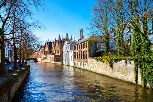 Bruges, Belgium - April 10, 2016: Scenic cityscape with houses, bridge and Green canal, Groenerei in Bruges, Belgium