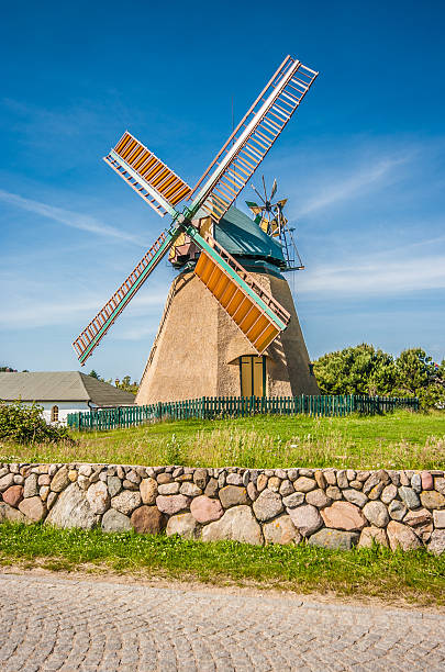 Traditional windmill in beautiful scenery with blue sky and clouds on a sunny day in summer.