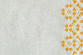 Embroidered fragment on flax by yellow and white cotton threads.