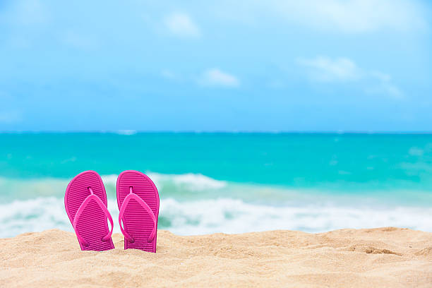 Slippers on the beach Pair of colorful slippers on the beach. weekend trip stock pictures, royalty-free photos & images
