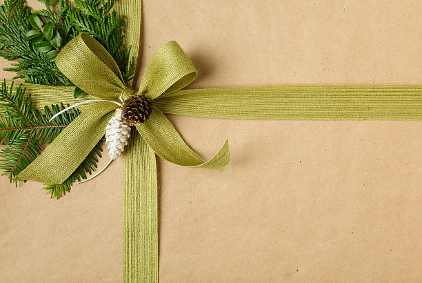 Photo of Christmas gift background with recycled wrapping paper and natural decorations